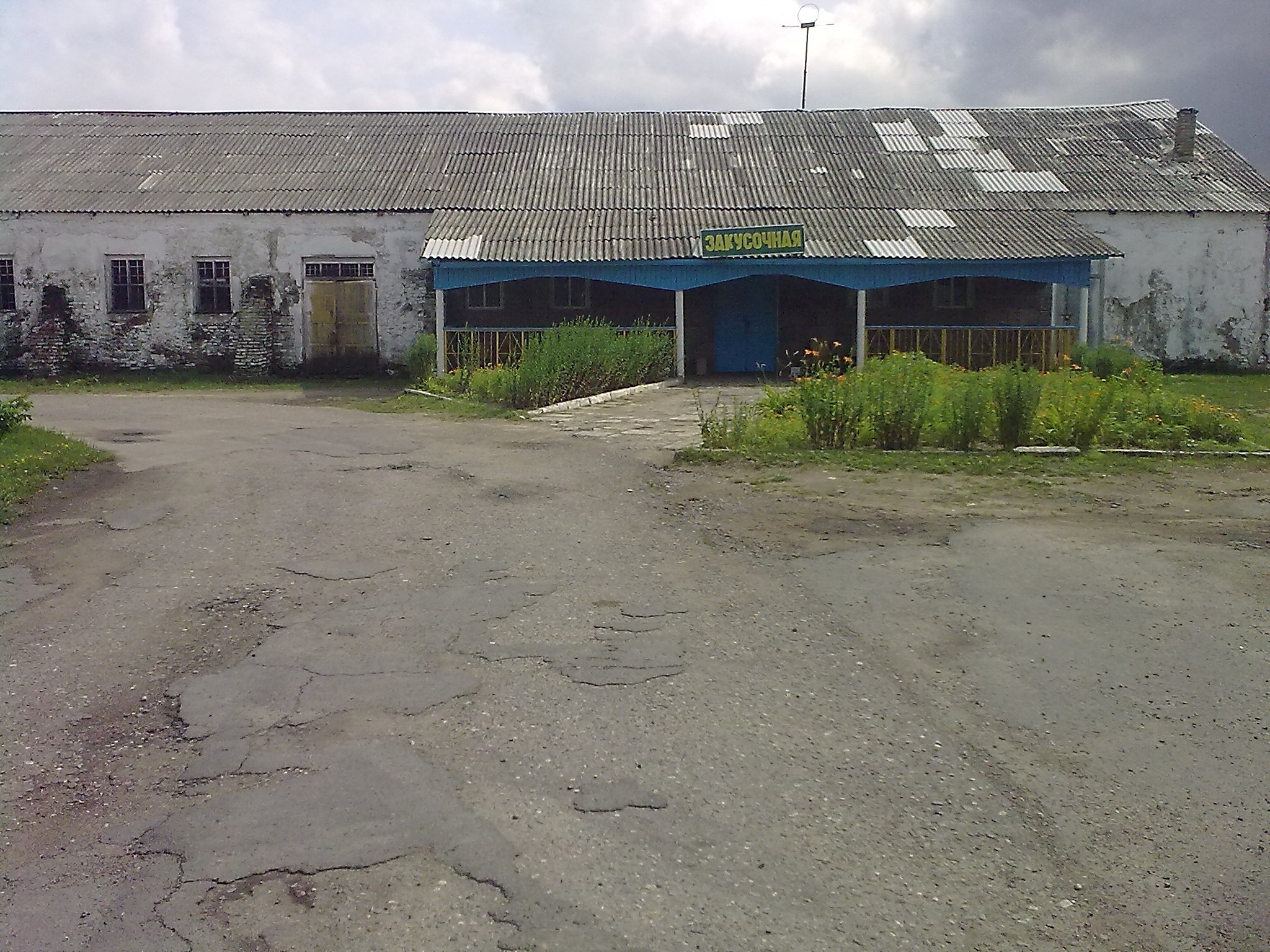 Messy building that looks abandoned with wooden sign that says 'Eatery'. The place was working though.