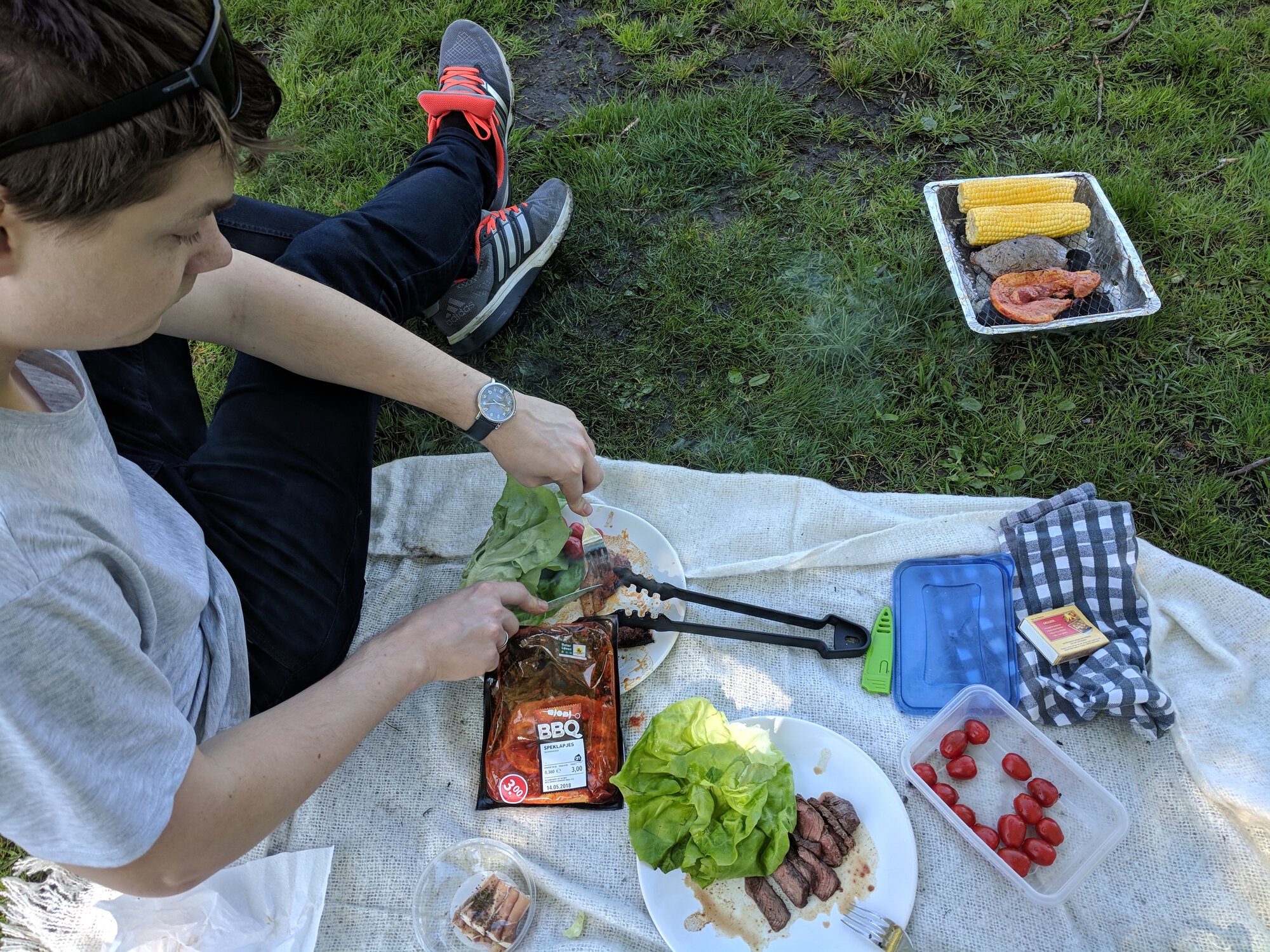Dima cuts grilled meat and vegetables