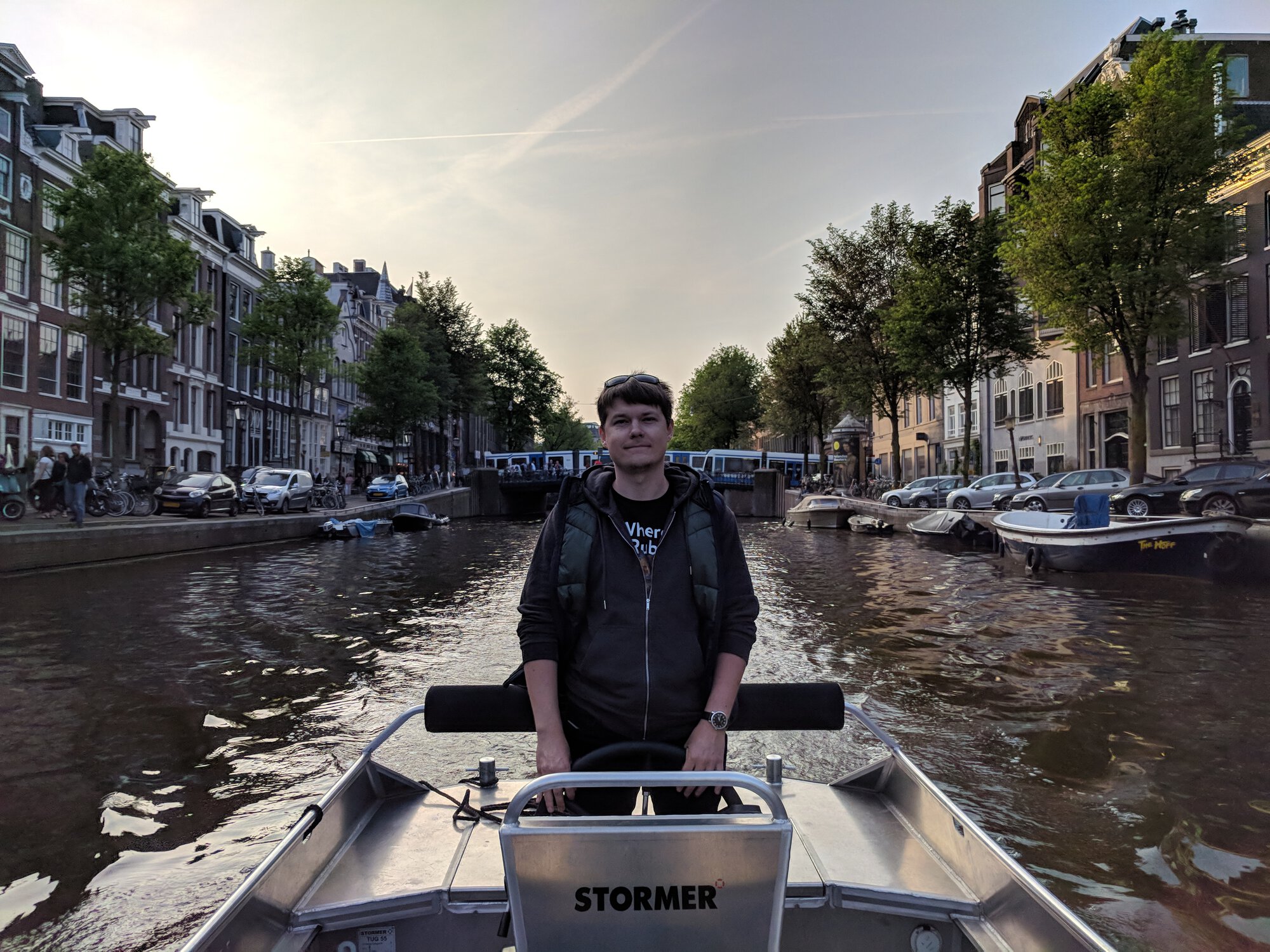 Dima drives a boat in Amsterdam