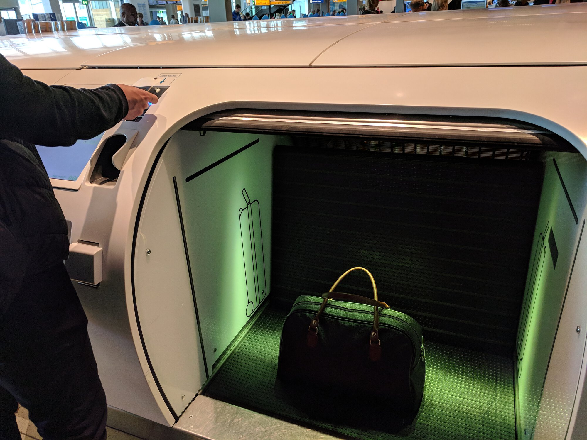 Dima puts a bag into a special box for checked baggage