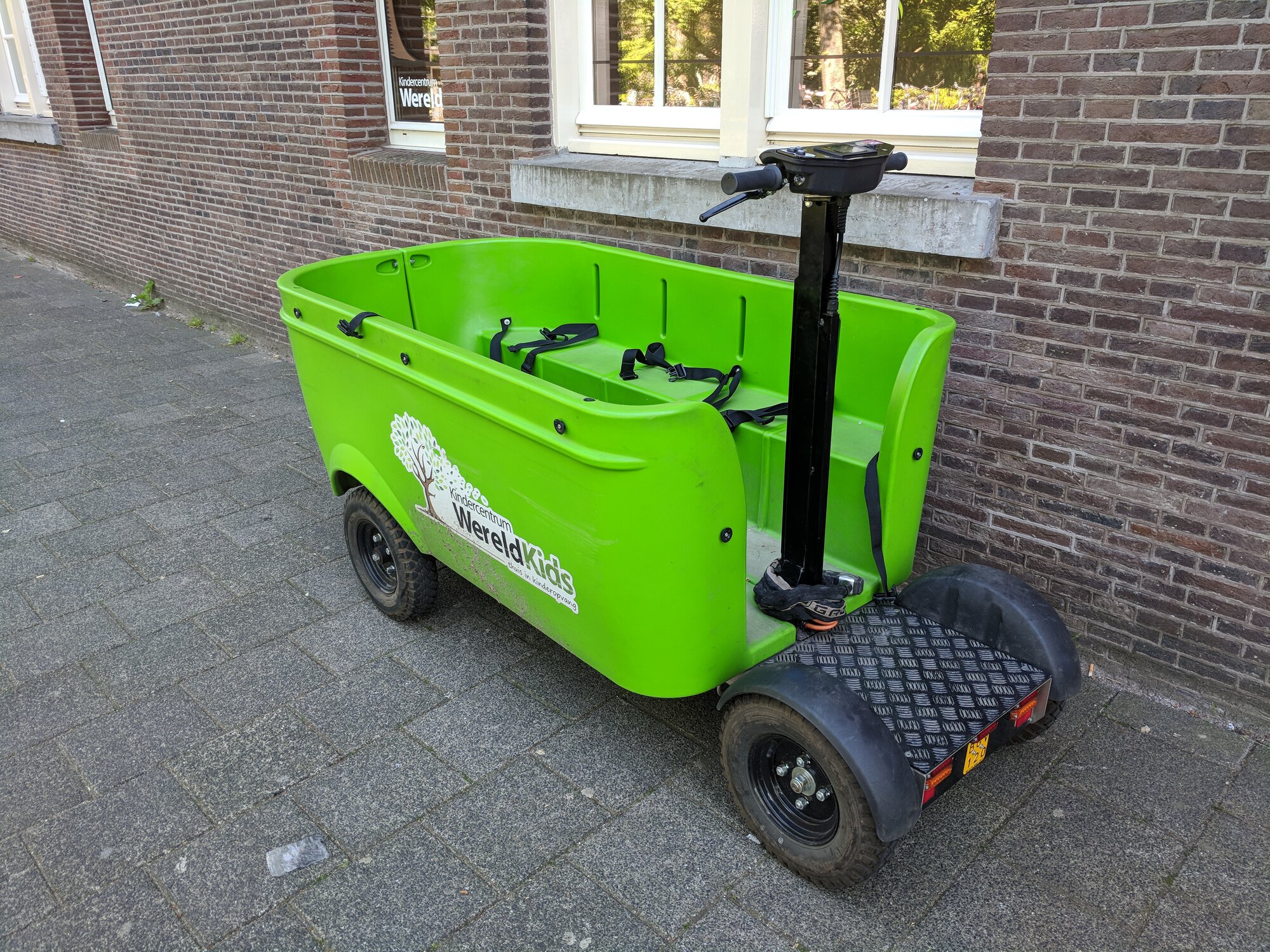 A segway with a box in front of it where kids can seat