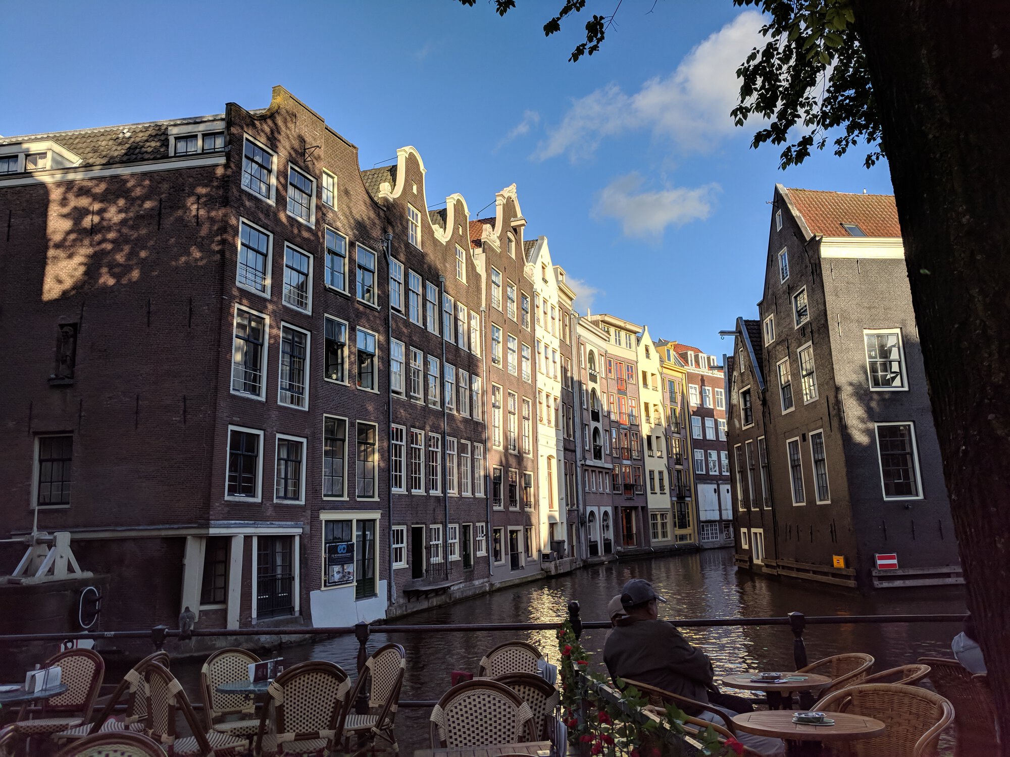 Cafe tables, canal and buildings staying in the water