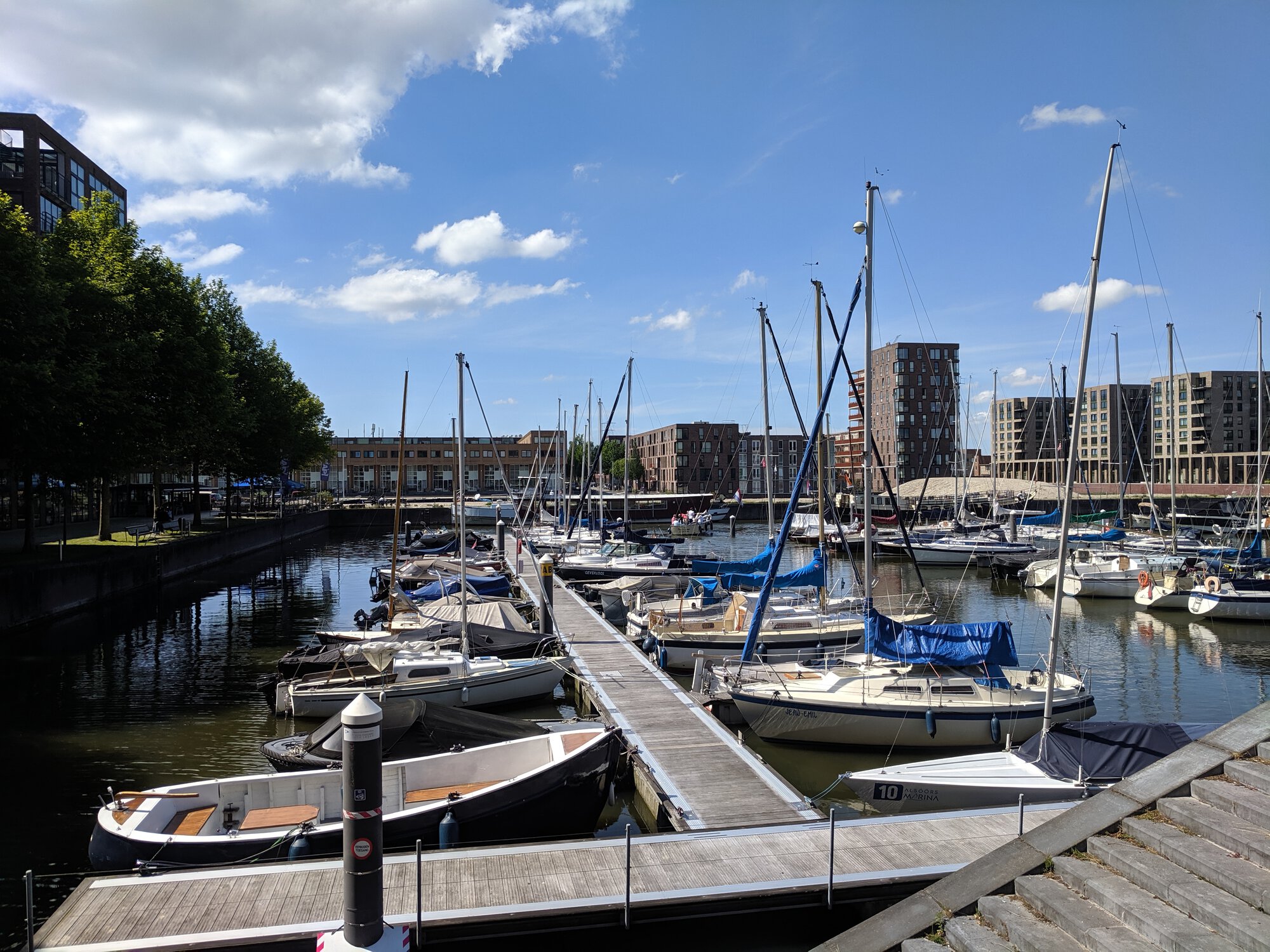 A ferry with many sailing boats