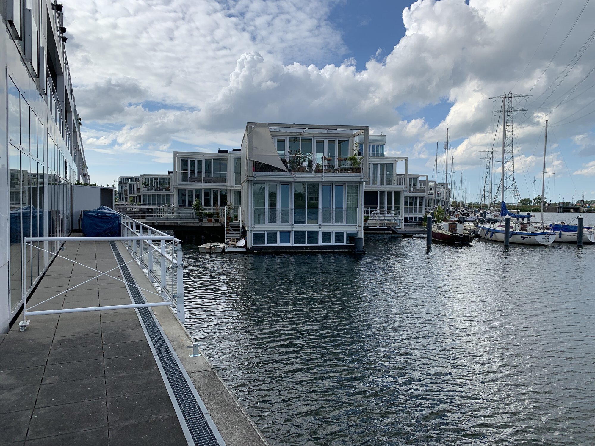 A house on water with sail boats nearby