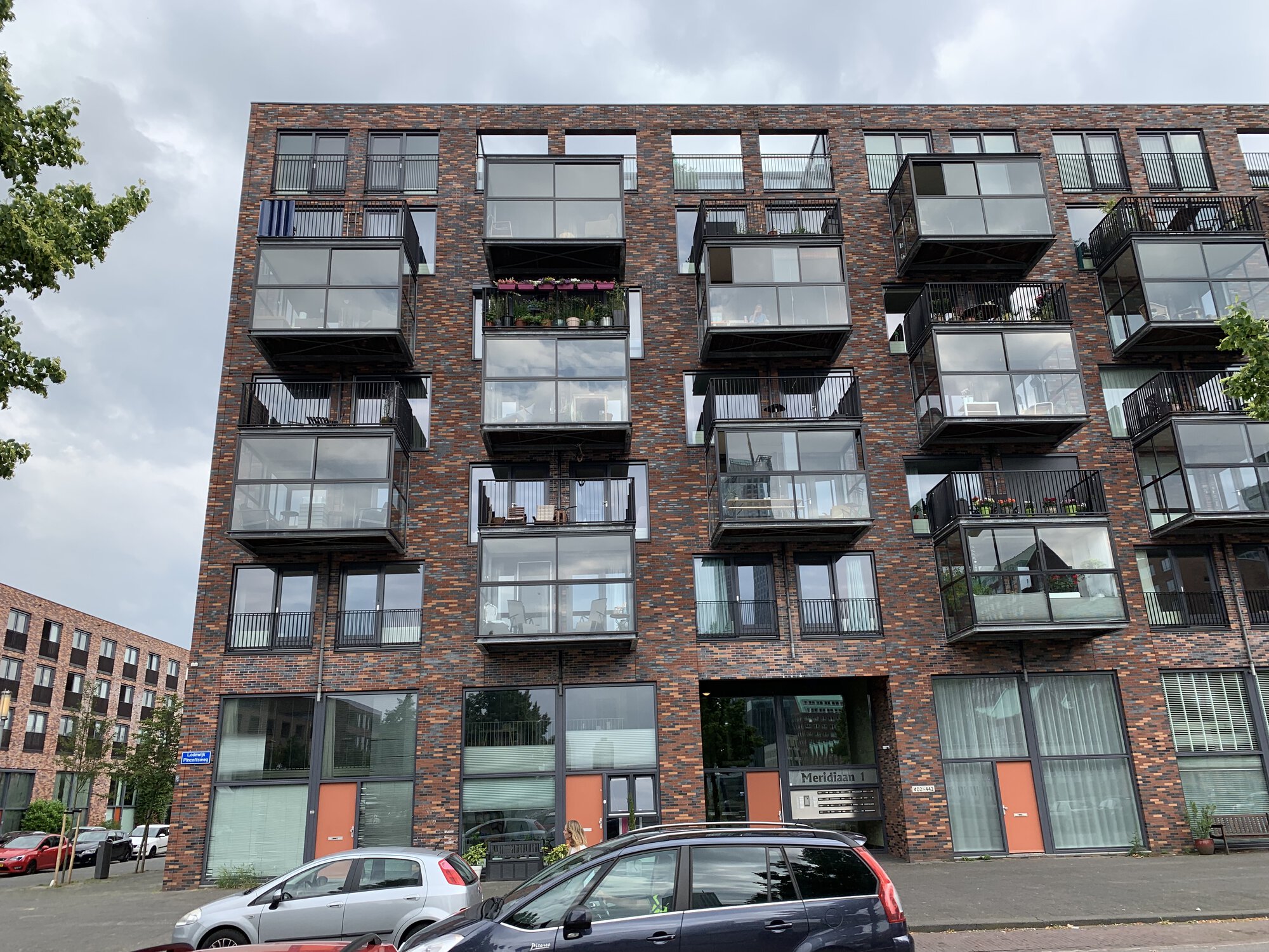 Photo of balconys: some people have chairs on their balcony, some have a lot of flowers. People enjoy their balconys